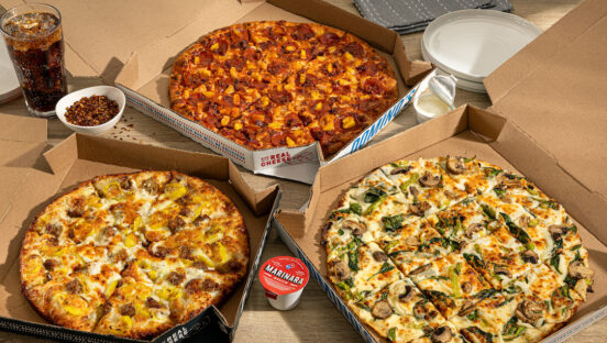 This photo shows an assortment of pizzas from Domino's.