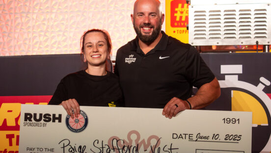 This photo shows the winner of the Rush Competition holding an oversized check for $4,000, presented by CEO Adam Oldenburg.