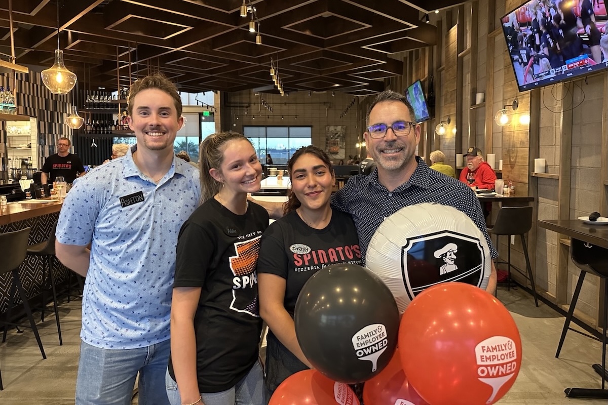 This photo shows Spinato's CEO Anthony Spinato holding balloons with two female and one male employees in the brand's Tempe location.
