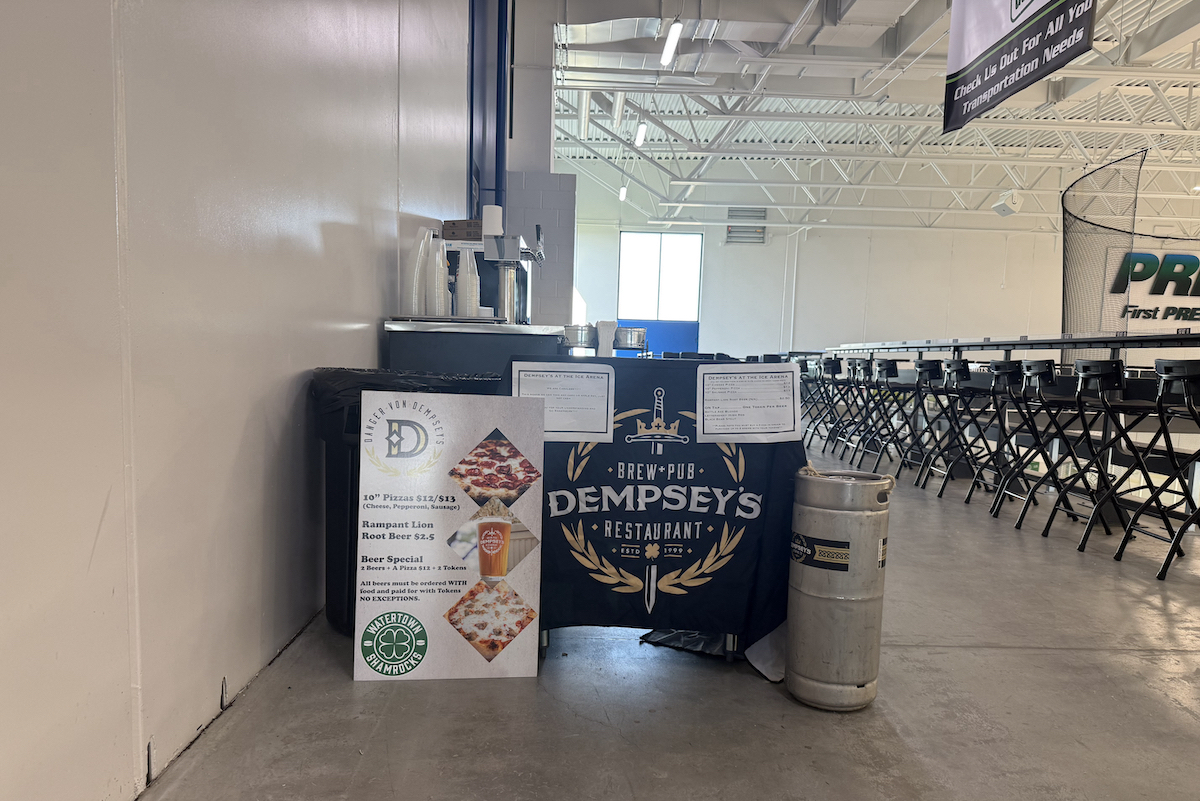 This photo shows Sean Dempsey's pizza stand in a hallway at a hockey rink.