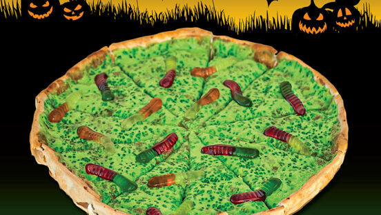 This photo shows a pizza with a green Bavarian cream base that's topped with gummy worms.