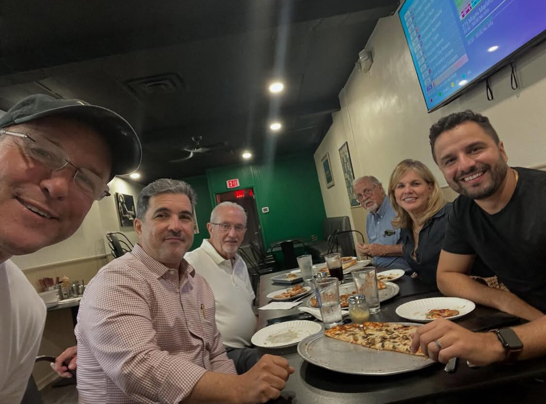 This photo shows owner Thad Winieckie in a selfie with several happy customers.