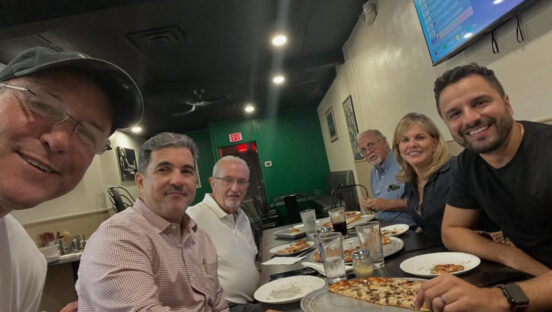 This photo shows owner Thad Winieckie in a selfie with several happy customers.