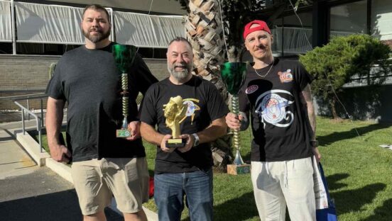 This photo shows Will Grant with his trophy along with two other Pizza World Cup winners.