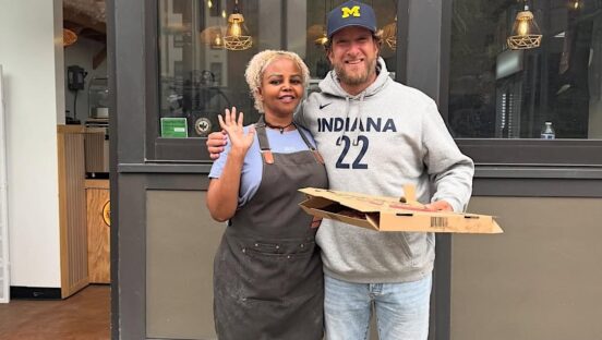 This photo shows Dave Portnoy in front of Artisan Pizza Cafe with his arm around owner Jasmin Ahmed.