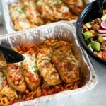 This photo shows several items from Picazzo's catering menu, including the Chicken Parmesan and the Mother Earth Salad.