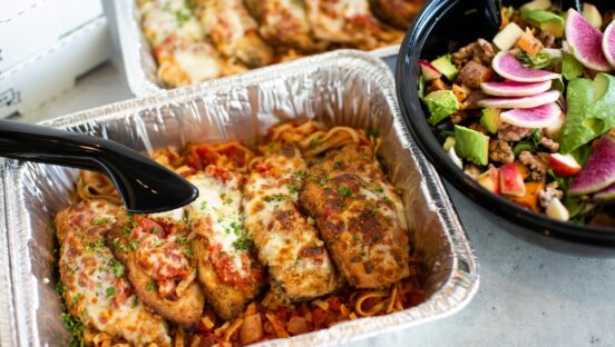 This photo shows several items from Picazzo's catering menu, including the Chicken Parmesan and the Mother Earth Salad.