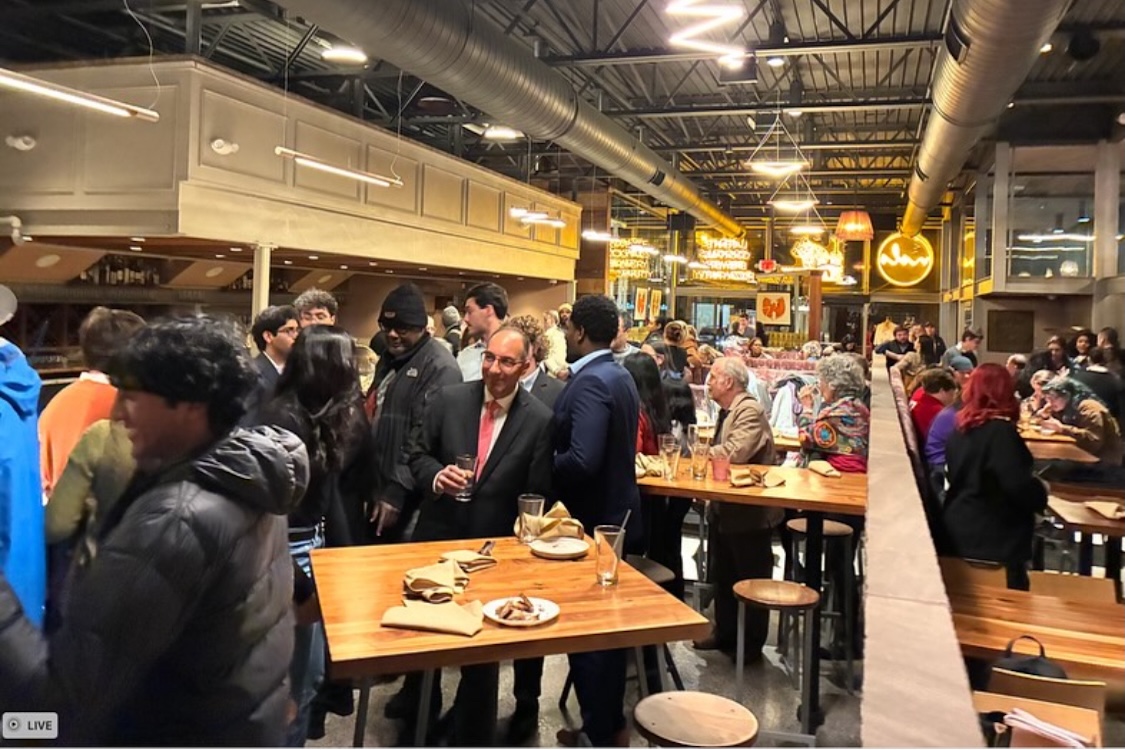 This photo shows a large gathering of men and women for a party at Nolo Pizzeria.