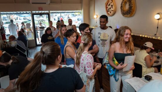 This photo shows a long line of customers waiting to place an order at Lena Pizza & Bagels.