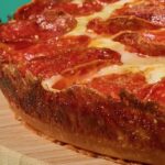 This photo shows the crusty edge of a pan pizza.