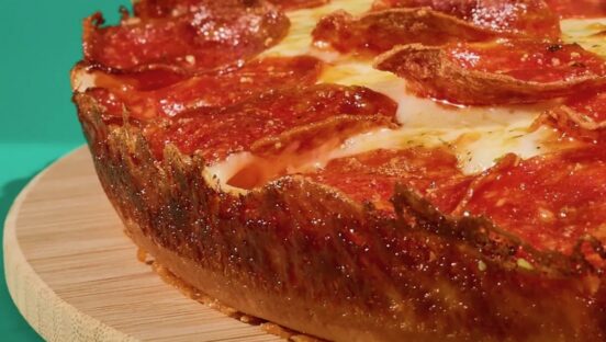 This photo shows the crusty edge of a pan pizza.