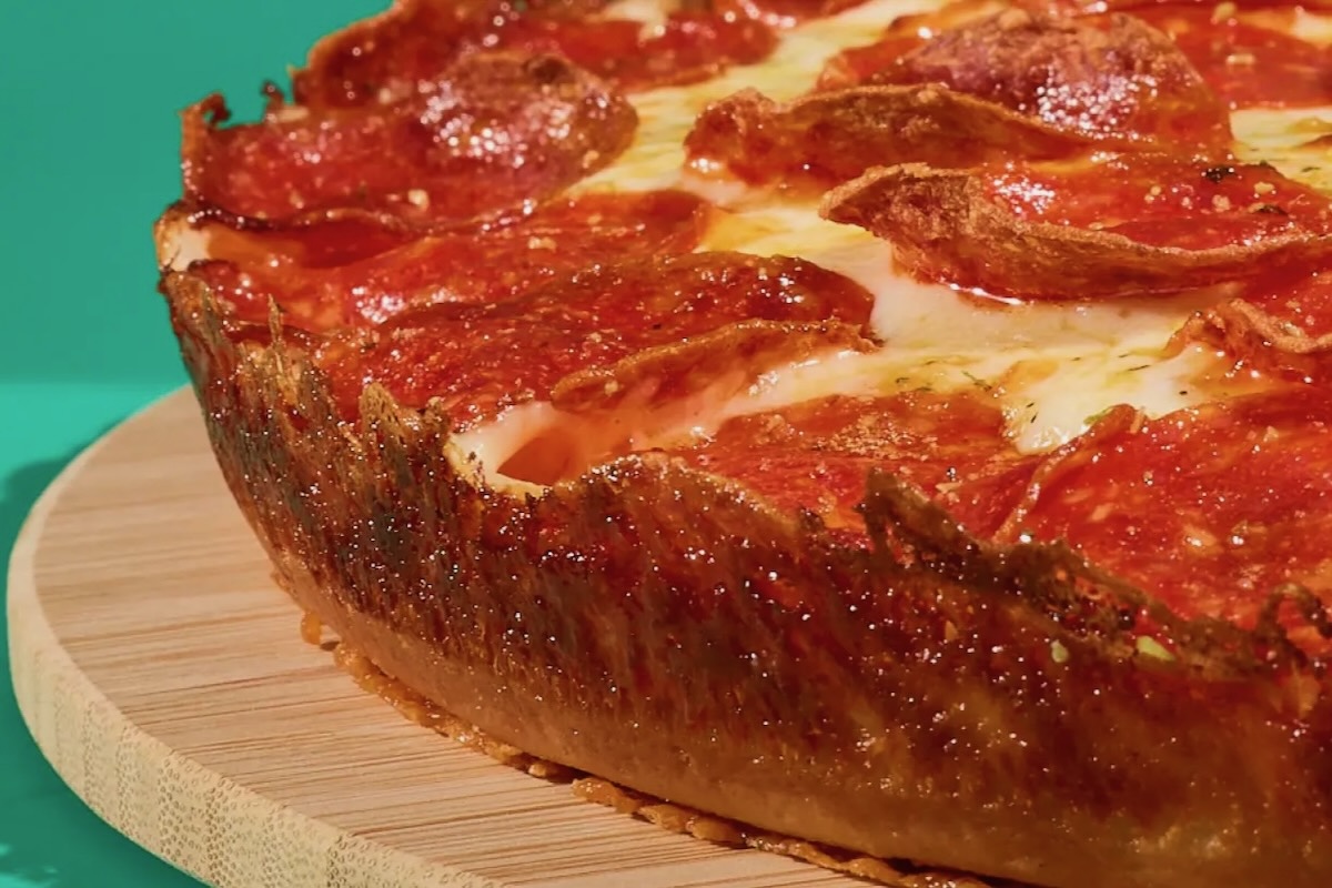 This photo shows the crusty edge of a pan pizza.