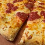 This photo shows a close-up of a pepperoni and cheese pizza.