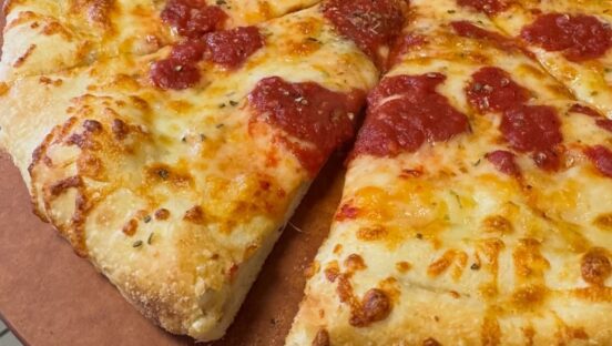 This photo shows a close-up of a pepperoni and cheese pizza.
