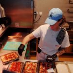 This photo shows Jess making several different pizzas in her kitchen.