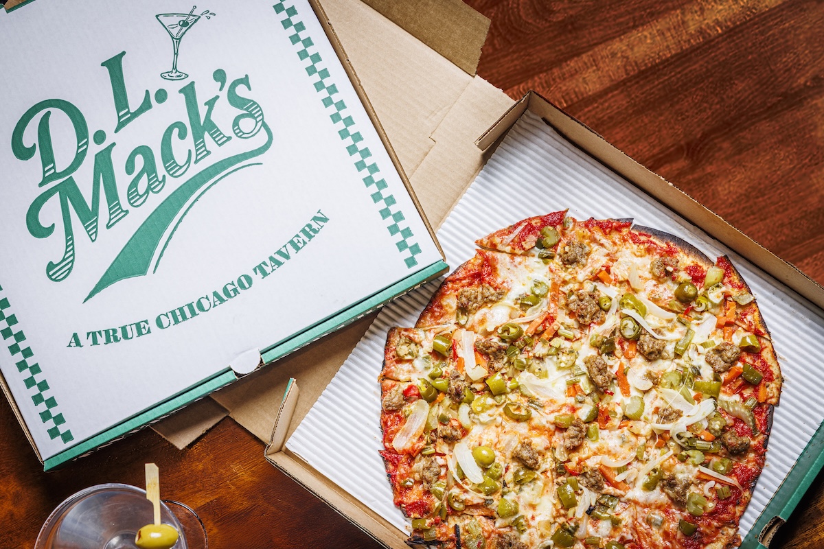 This photo depicts a D.L. Mack's pizza box and a pizza topped with sausage, giardiniera and sweet onions.
