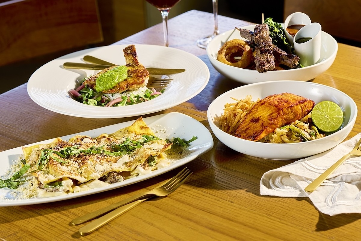 This photo shows several of the menu items listed in the story, including a lasagna dish, the pan-roasted chicken, the salmon and the filet skewers.