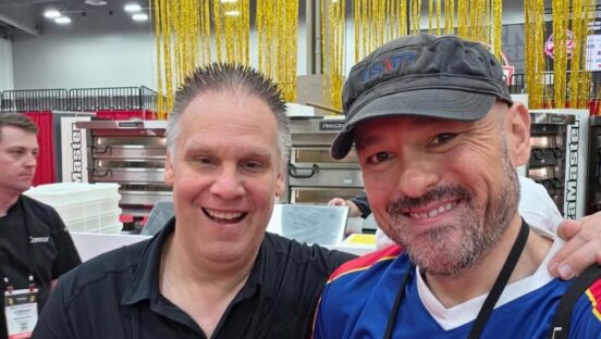 This photo shows Brian Weavel smiling with his arm around Brian Hernandez at a pizza industry event.