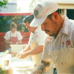This photo shows Nick Camacho making his pizzas at an outdoors event catered by Lucky Nick's Pizza.