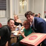 This photo shows Sal Lupino bringing pizza to members of the Best Buddies organization.