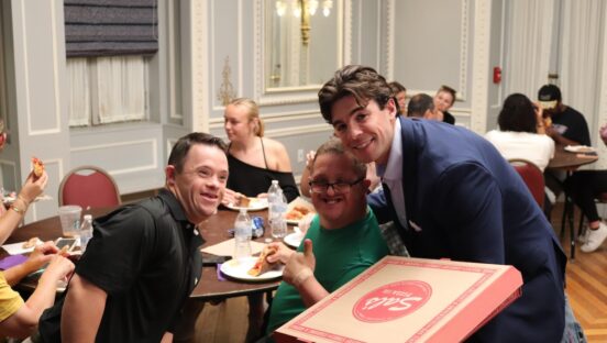 This photo shows Sal Lupino bringing pizza to members of the Best Buddies organization.