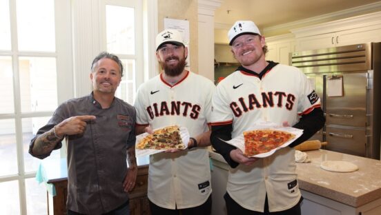 This photo shows Tony Gemignani standing next to Logan Webb and Ryan Walker, each holding his own pizza.
