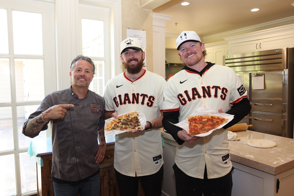 This photo shows Tony Gemignani standing next to Logan Webb and Ryan Walker, each holding his own pizza.