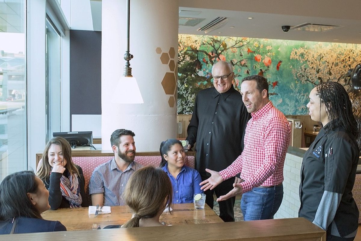 Dan Simons of Founding Farmers meets with employees.