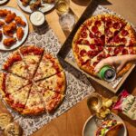Customers share pizzas and other menu items at Your Pie.