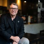 Brett Willis of Latitude Food Group sits in a restaurant.