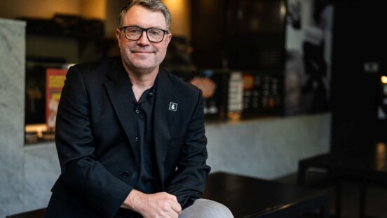 Brett Willis of Latitude Food Group sits in a restaurant.