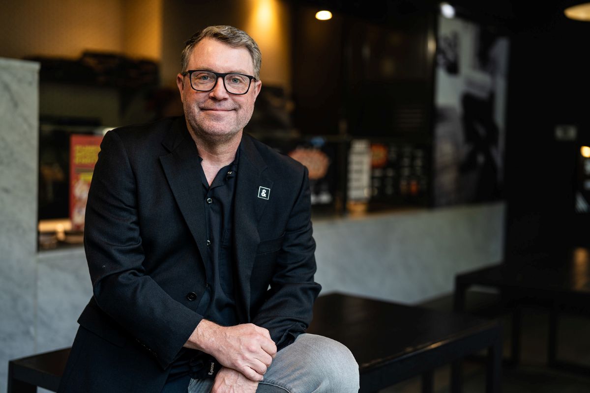 Brett Willis of Latitude Food Group sits in a restaurant.
