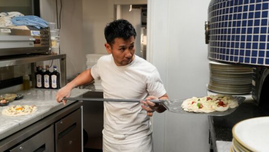 Tsubasa Tamaki, pizzaiolo at Pizza Studio Tamaki, tends the oven at his New York City pizzeria.