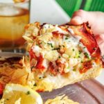 This photo shows a slice of lobster pizza from Grandma Bob's.
