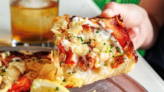 This photo shows a slice of lobster pizza from Grandma Bob's.