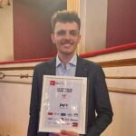 This photo shows Joe Powers holding his 50 Top Pizza award in 2025.