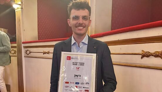 This photo shows Joe Powers holding his 50 Top Pizza award in 2025.