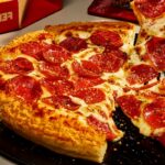 This photo shows Pizza Hut's new Crispy Parm Pan Pizza topped with pepperoni.
