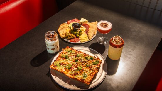 this photo shows an Elote street corn pizza alongside a meat and cheese board from Via 313.