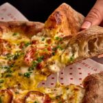 This photo shows Zarella's carbonara pizza with fra’mani smoked pancetta, pecorino and egg.