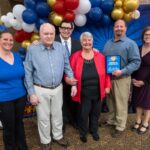 This photo shows Tom Sacco with the winners of Happy Joe's "Servant Hearts" awards.