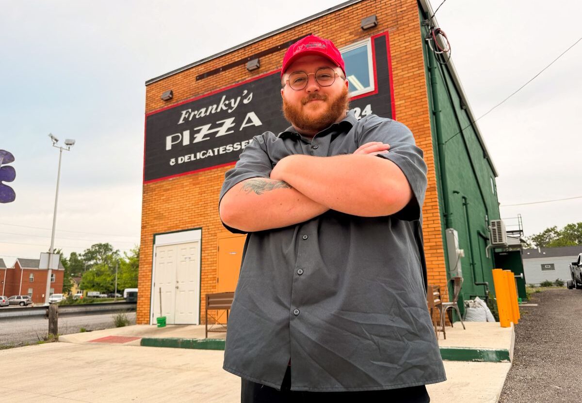 Benjamin Hoover, executive chef and co-owner, stands in front of Franky’s Pizza & Delicatessen in Warren, Ohio
