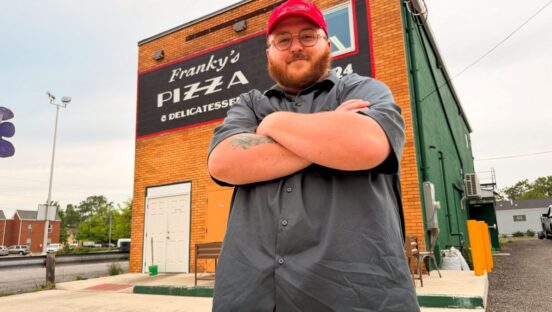 Benjamin Hoover, executive chef and co-owner, stands in front of Franky’s Pizza & Delicatessen in Warren, Ohio