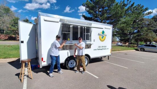 Ron Hurley and John Schultz pose in front of their mobile business, Parkway Pizza in Littleton, Colorado