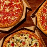 This photo shows three different pizzas with varying topics from Pizza Hut.