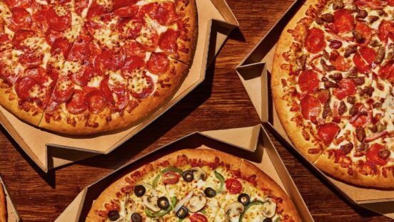 This photo shows three different pizzas with varying topics from Pizza Hut.
