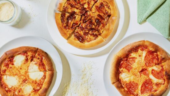 This photo shows a trio of pizzas offered at CPK.