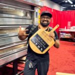 This photo shows Juan Robles holding one of his trophy peels after winning the California Pizza Challenge last year.