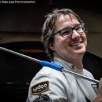 This phots shows Sean Dempsey smiling in his white USPT chef jacket with a metal peel slung over his shoulder.