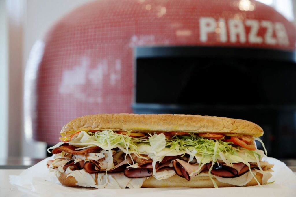 Panini sandwich and brick oven pizzeria oven at Piazza Pizza & Beach Bodega